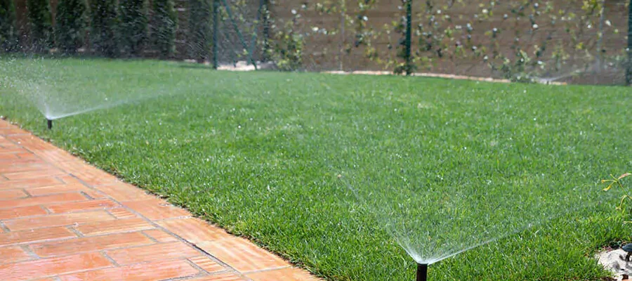 green lawn with open sprinklers